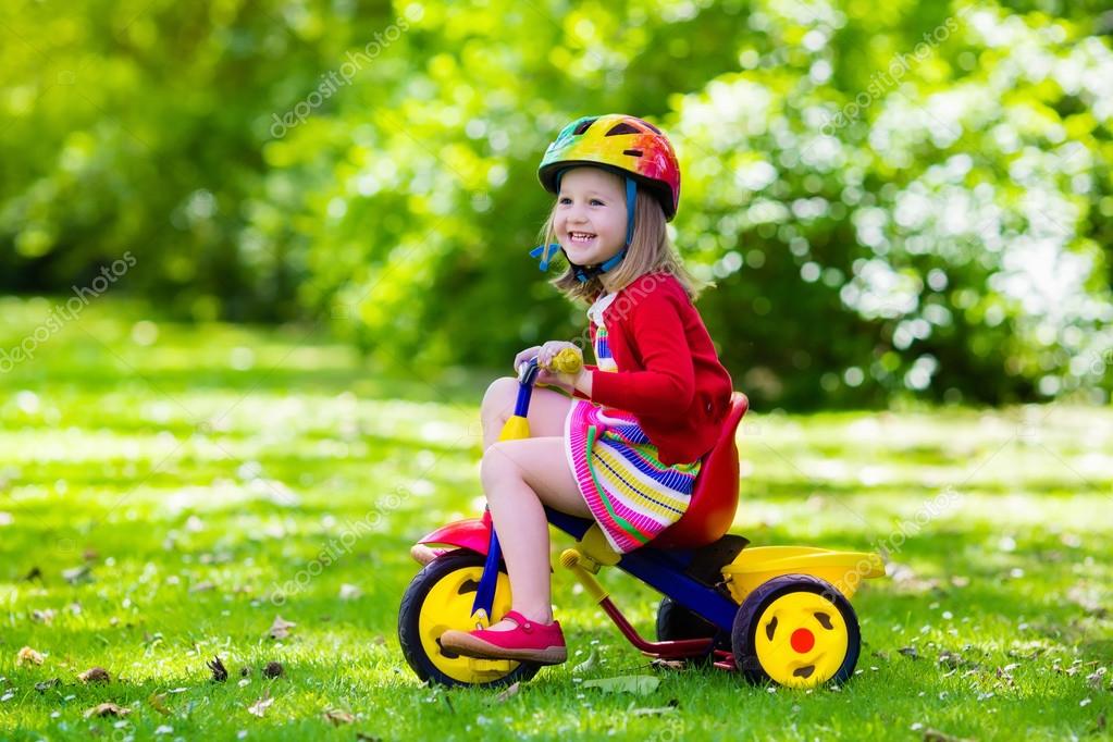 kid riding tricycle
