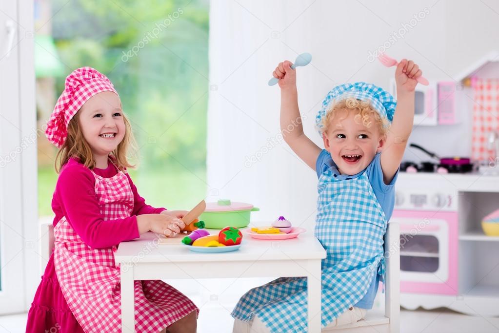 Kids playing with toy kitchen — Stock Photo © FamVeldman 114352292