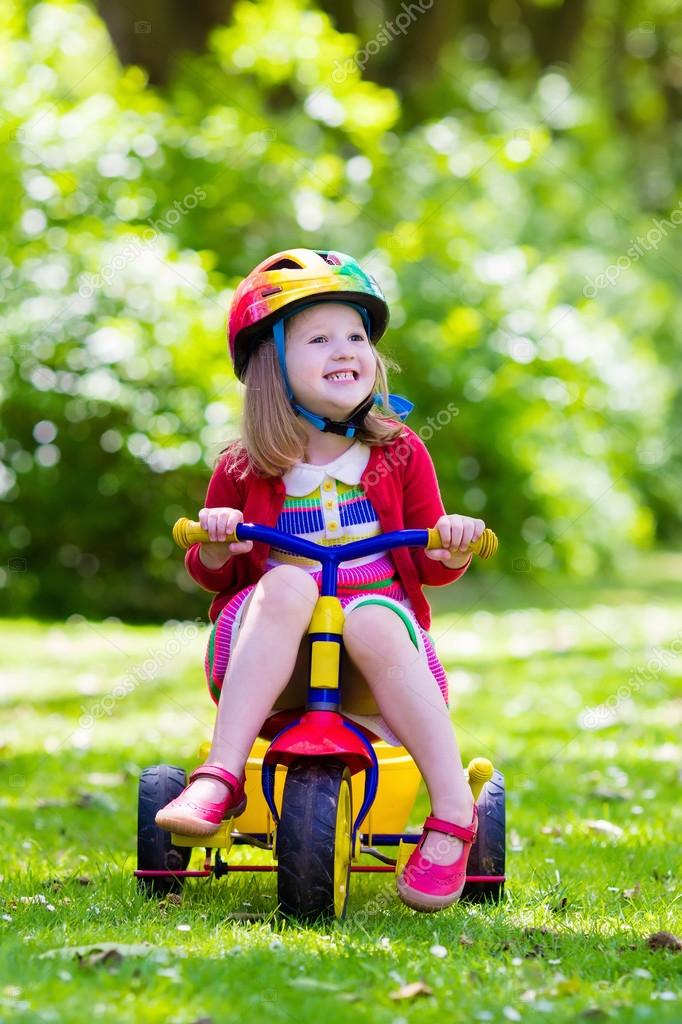 girl riding tricycle