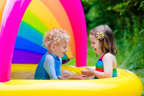 Kids playing in inflatable pool — Stock Photo, Image