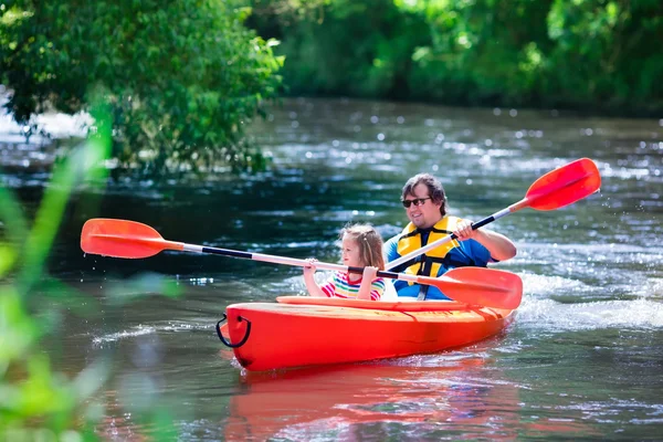 Father and child kayaking in summer