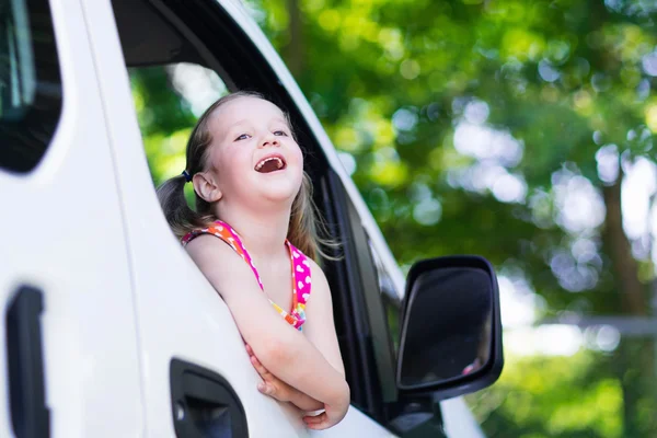 Little girl sitting in white car — Stock Photo, Image