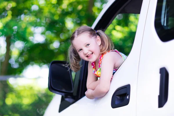 Little girl sitting in white car — Stock Photo, Image