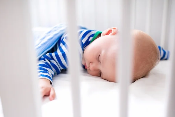 Сплячий хлопчик у білому ліжечку — стокове фото