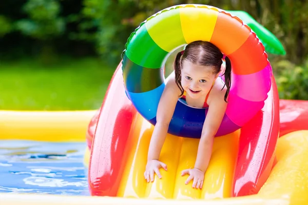 Little girl in garden swimming pool — Stock Photo, Image