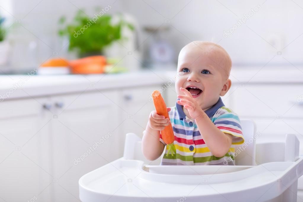 Little baby eating carrot — Stock Photo © FamVeldman 115152390