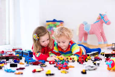 Little kids playing with toy cars clipart