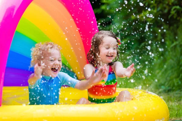 Kids playing in inflatable pool — Stock Photo, Image