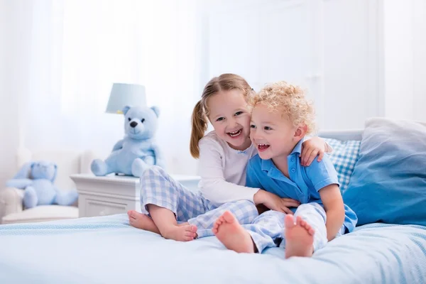 Kids playing in white bedroom — Stock Photo, Image