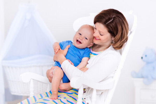 Mother and baby in white bedroom