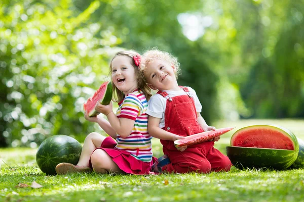 Kinderen eten watermeloen in de tuin — Stockfoto