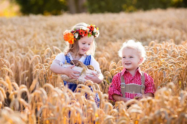 Kids in Bavarian costumes in wheat field — Stock Photo, Image
