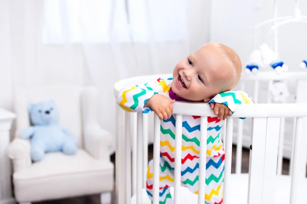 Little boy standing in bed — Stock Photo, Image