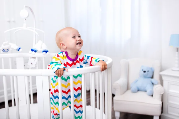 Little boy standing in bed — Stock Photo, Image