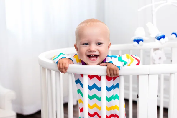 Little boy standing in bed — Stock Photo, Image