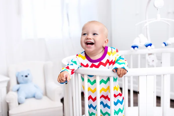 Little boy standing in bed — Stock Photo, Image