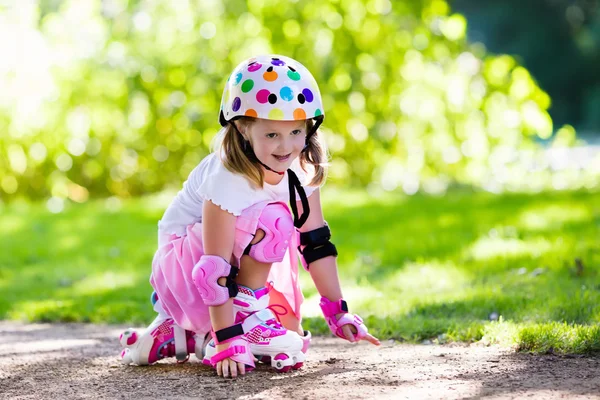 Petite fille avec des chaussures de patin à roulettes dans un parc — Photo