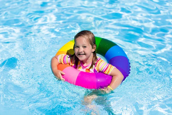 Little girl with toy ring in swimming pool — Stock Photo, Image