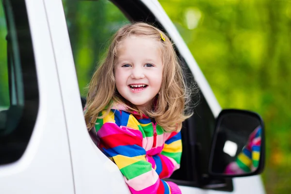 Little girl sitting in white car — Stock Photo, Image