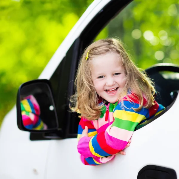 Little girl sitting in white car — Stock Photo, Image