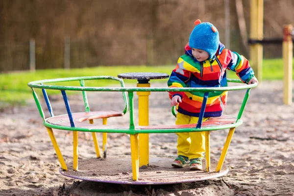 Little boy on playground in autumn
