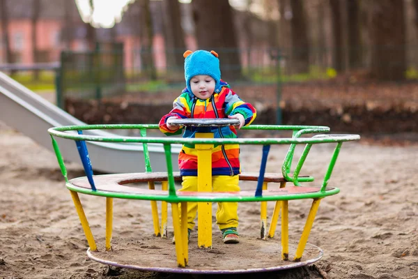 Little boy on playground in autumn — Stock Photo, Image