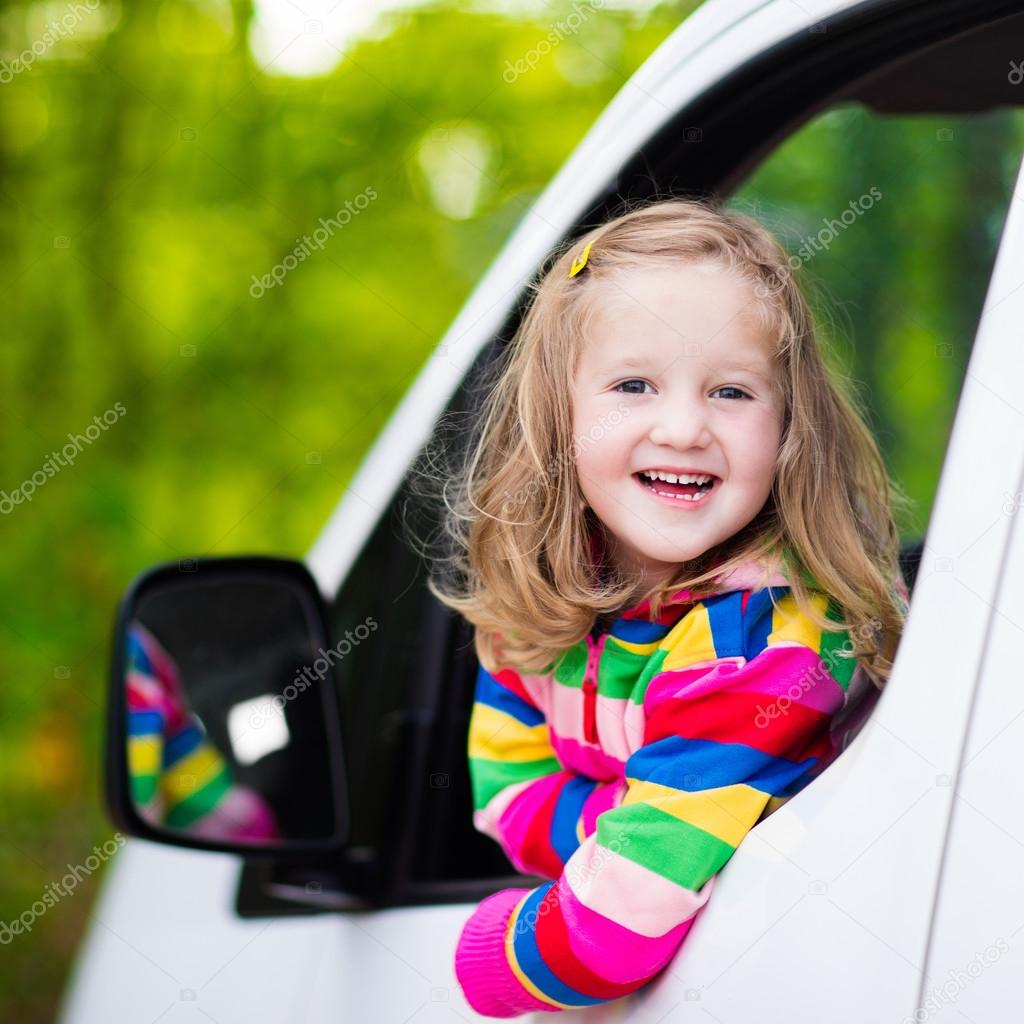 Little girl sitting in white car
