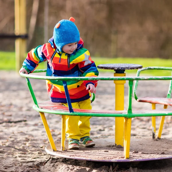 Little boy on playground in autumn — Stock Photo, Image