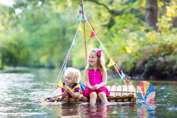 Kids on wooden raft — Stock Photo, Image