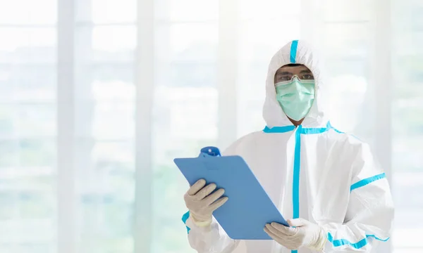 Doctor in hazmat suit and goggles in covid-19 pandemic. Hospital medical staff in protective wear, face shield and mask. Asian doctor or nurse fighting coronavirus outbreak. Clinic personnel.