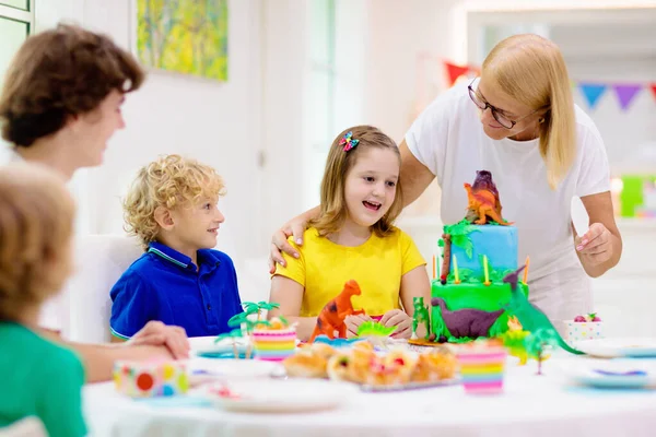 Kids Birthday Party Dinosaur Theme Cake Little Girl Blowing Candles —  Fotos de Stock