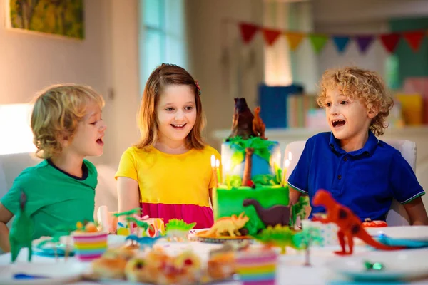 Kids Birthday Party Dinosaur Theme Cake Little Girl Blowing Candles — Stock Photo, Image