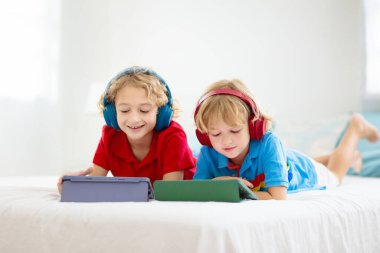 Tablet bilgisayarı olan çocuk. Çocuklar çevrimiçi çalışıyor. Evde öğrenme ve öğrenme için elektronik cihaz. Bilgisayarlı küçük çocuk. Çocuklar için Gadget ve ekran zamanı. Evdeki çocuk. Uzak okul.