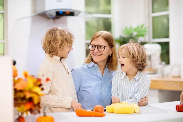 Family Cooking Thanksgiving Dinner Grandmother Child Cut Pumpkin Decorated Kitchen — Stock Photo, Image