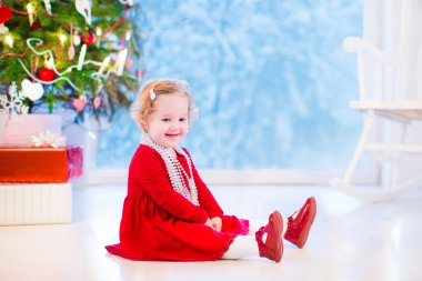 Little girl under Christmas tree clipart
