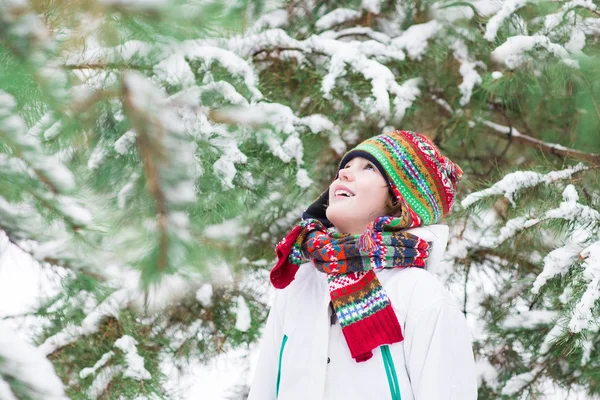 Happy child playing in a snowy forest — Stock Photo, Image