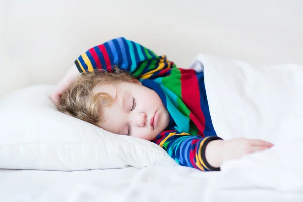 Funny sleeping toddler girl in a white bed — Stock Photo, Image