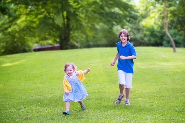 Happy kids running in a park — Stock Photo, Image