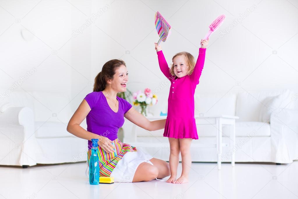 Mother and daughter sweeping the floor