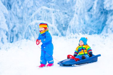 Little children enjoying a sleigh ride