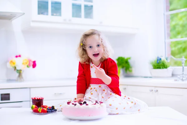 Kleines Mädchen backt Erdbeerkuchen — Stockfoto