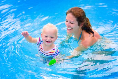 Mother and baby in swiming pool clipart