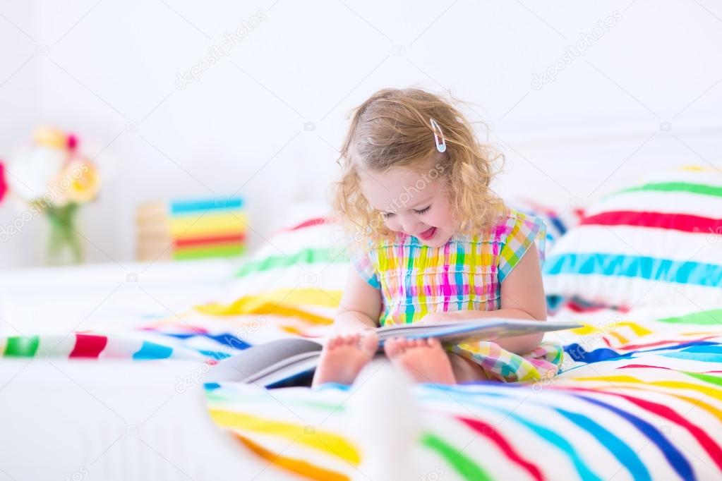 Little girl reading a book