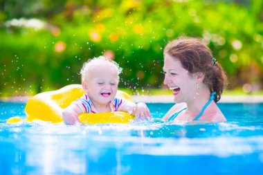 Mother and baby in swiming pool clipart