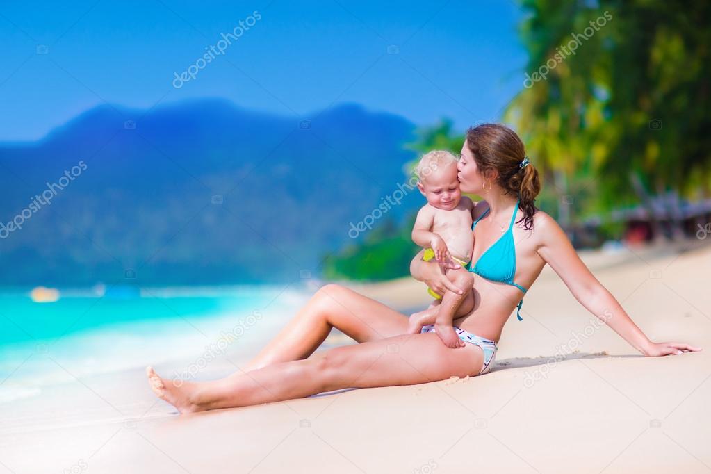 Mother and baby at a tropical beach