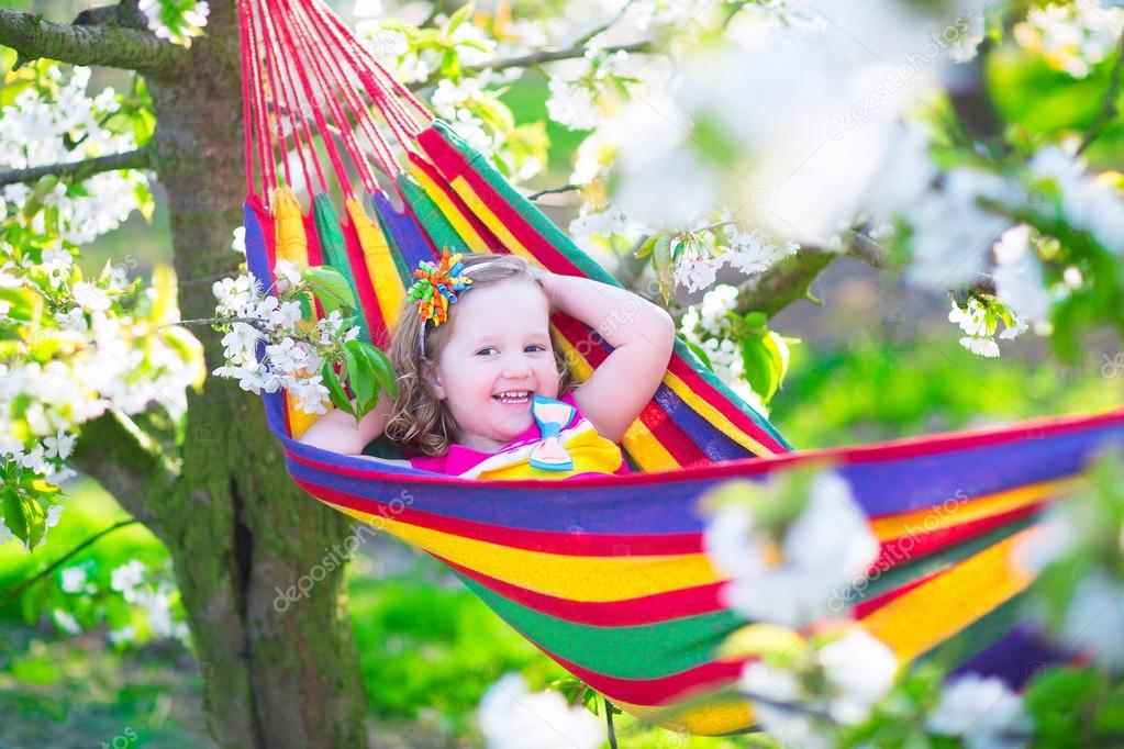 Little girl relaxing in a hammock