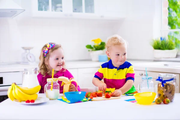 Barn förbereder frukost i ett vitt kök — Stockfoto