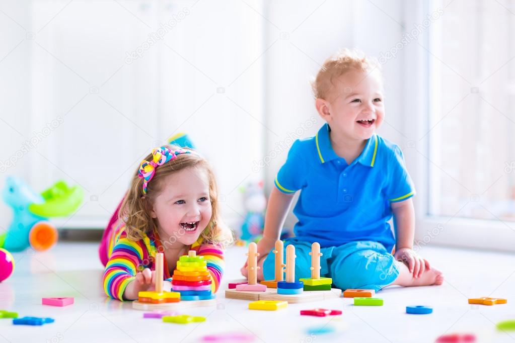 Cjildren playing with wooden toys