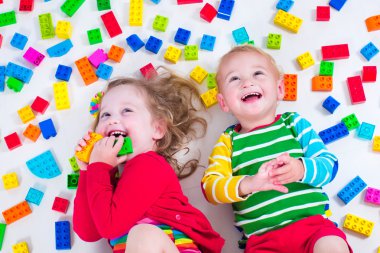 Kids playing with colorful blocks clipart