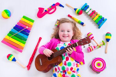 Little girl with music instruments clipart